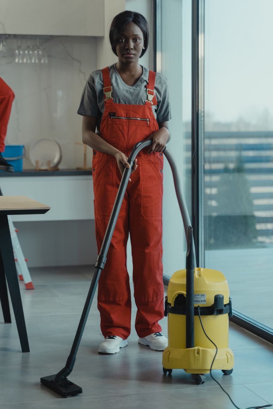A tool bag and drill on a wooden floor