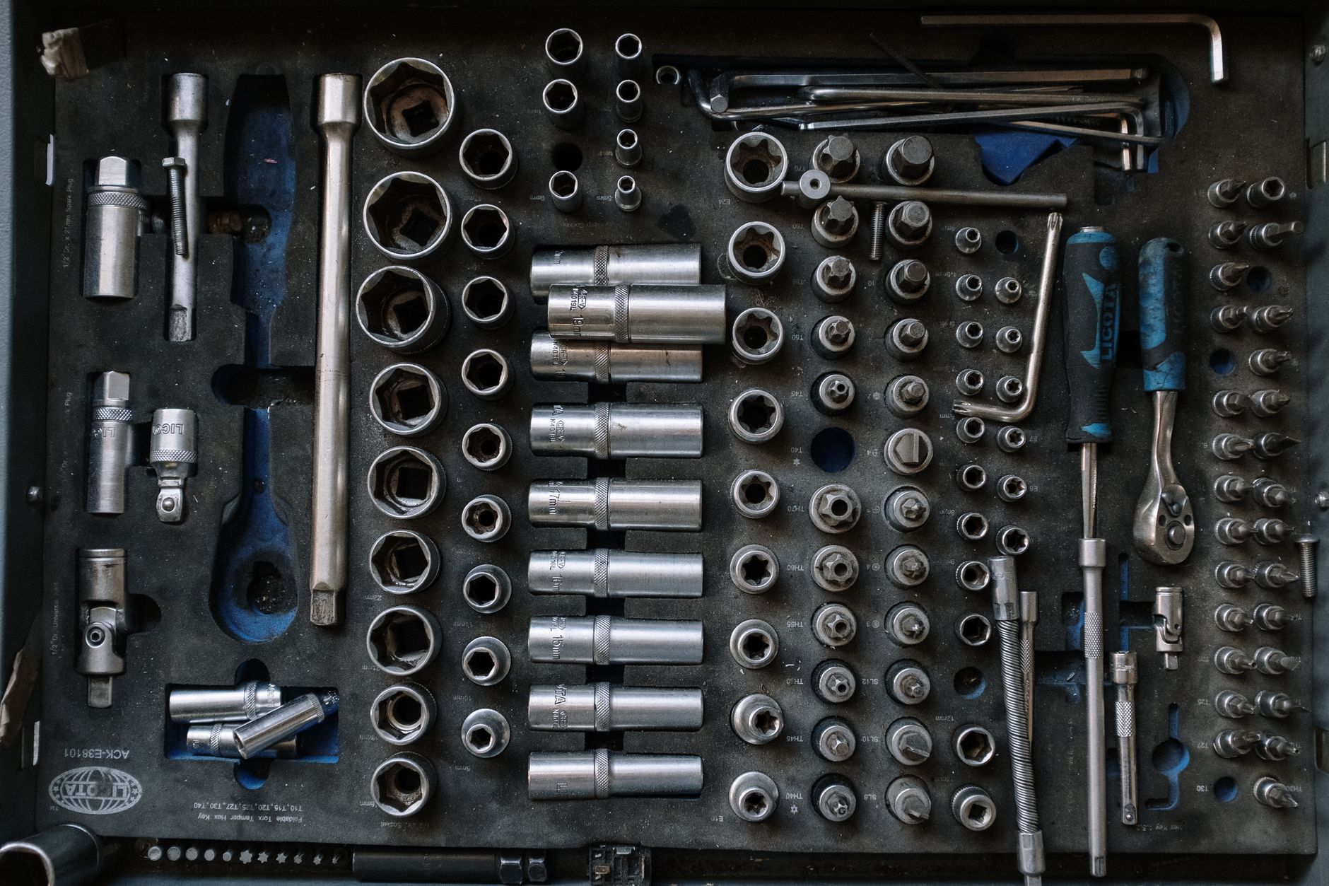 A handyman repairing a cabinet hinge